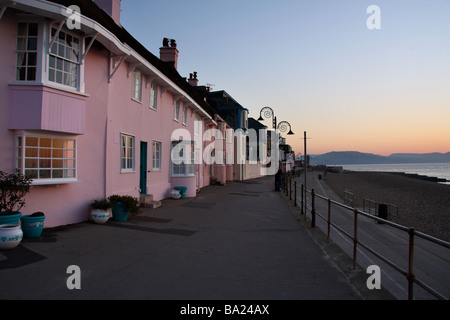 Una vista del dipinto luminosamente case sulla Lyme Regis fronte mare di sunrise Foto Stock