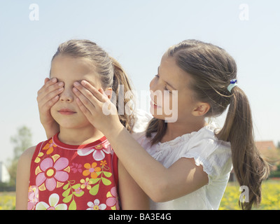 Ragazze sorella occhi ritratto mantenere chiusa la gente bambino-ritratto bambini 9 anni due fratelli gemelli amici di infanzia divertente gioco di gioia Foto Stock