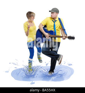 Licenza disponibile su MaximImages.com - uomo con una chitarra e una donna che balla in una pozzanghera Foto Stock