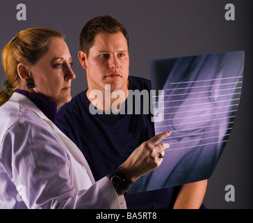 Doctor discusses x-ray/MRI with patient Stock Photo