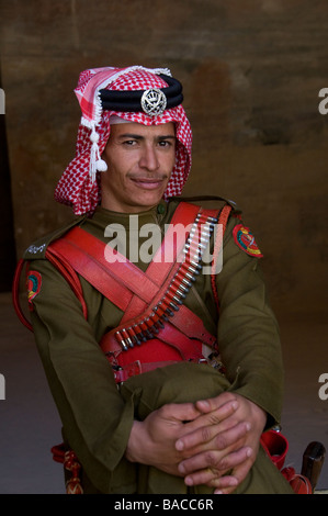 Ufficiale delle forze beduine giordane con l'indirizzo rosso e bianco del keffiyeh e la cintura di munizioni tradizionale a Petra Jordan Foto Stock