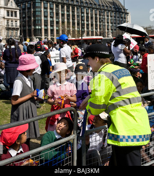 Una donna poliziana amichevole Metropolitan parlò con le scolaresche tamil ad una protesta a Westminster a Londra. Foto Stock