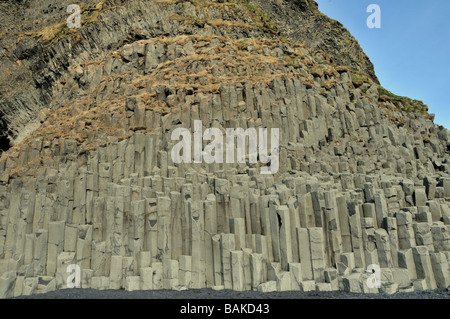 Imponenti colonne di basalto in scogliere al di sopra delle sabbie nere a Reynishverfi, Gardar, sulla punta meridionale di Islanda Foto Stock