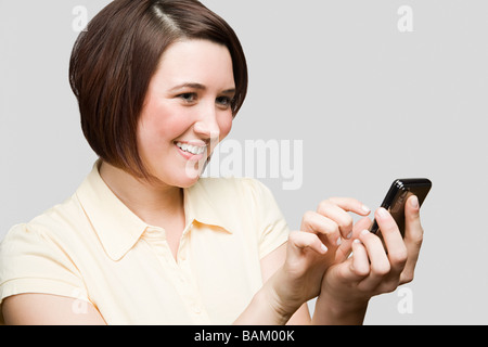 Ragazza adolescente utilizzando un telefono cellulare Foto Stock