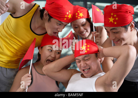 Giovane uomo facendo Sit-Ups essendo applauditi Foto Stock