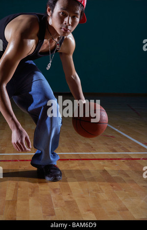 Hip Giovane giocare a basket su corte Foto Stock