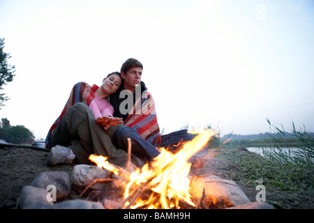 Coppia giovane Camping davanti al fuoco Foto Stock