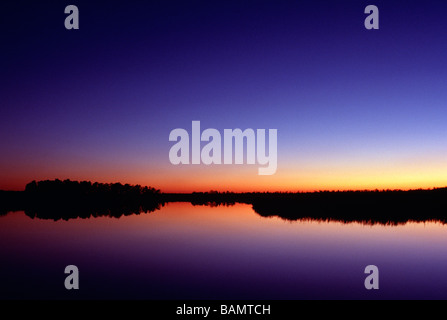 Viola e rosso del cielo al sorgere del sole su maree piscine in New Jersey USA Foto Stock