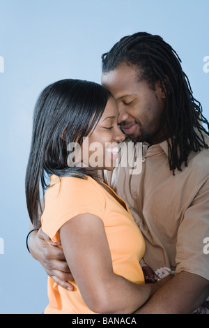 Giovane africano giovane che abbraccia con gli occhi chiusi Foto Stock
