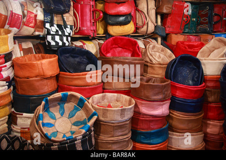 Tradizionale marocchino cuscinipoufs in pelle/sedili soft & sacchetti per la vendita in un negozio di conceria nel profondo della profondità del Fes/medina di Fez, Marocco Foto Stock