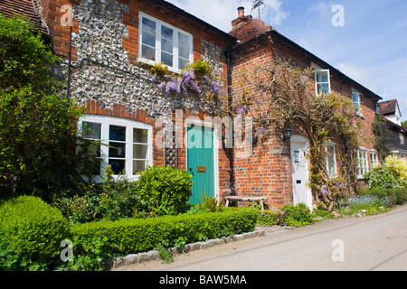 Turville scena del Vicario di Dibley è stata filmata tipico e pittoresco vecchio cottage Inglese in mattoni rossi & rivestita in pietra focaia privet hedge Alba francese Foto Stock