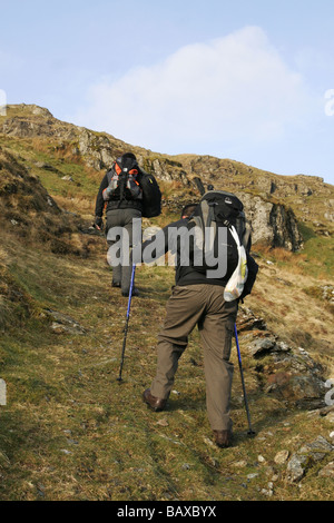 A Piedi nel paese deserto trail scalare le montagne rocciose, erba percorso coperto sul lato della collina,migliaia di piedi-up Foto Stock