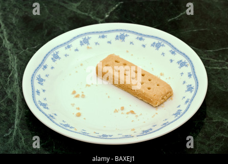 Un cookie frollini dito su un bianco lastra decorata Foto Stock