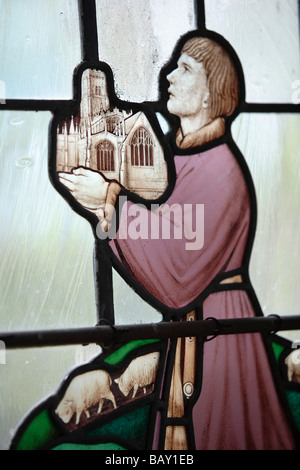 Il vetro macchiato immagine di un mercante di lana tenendo la lana la chiesa di San Pietro e San Paolo, Northleach, Gloucestershire, Regno Unito Foto Stock