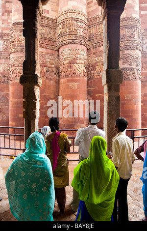 I turisti indiani a Qutb Minar tramite pilastri indù a Qutb Minar a Delhi in India Foto Stock