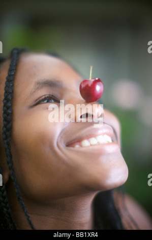 Donna con cherry sul naso, Pietermaritzburg, KwaZulu-Natal, Sud Africa Foto Stock