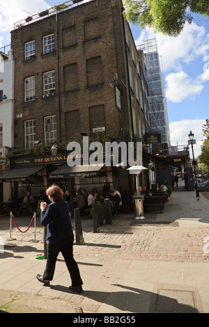 La Queens Pub dispensa, Cosmo posto, con al di fuori di bevitori e fumatori, Bloomsbury, London, Regno Unito Foto Stock