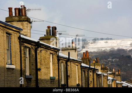 Una scena invernale, come la neve copre i tetti e i camini di Saltaire nel West Yorkshire Foto Stock