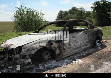 Un bruciato a guscio di una Mercedes Benz Coupe sinistra in terreni agricoli rurale Foto Stock