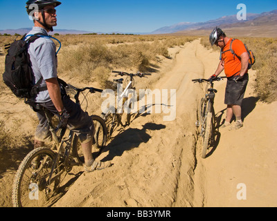 Gli amanti della mountain bike impantanati in profonda sabbia sciolta Foto Stock