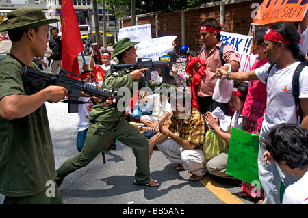 Pro democrazia i manifestanti si scontrano con altri manifestanti vestiti come soldati birmani di fronte all'Ambasciata birmano a Bangkok Foto Stock