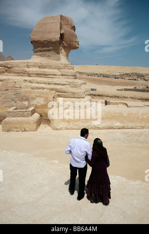 Giovane egiziano sull'Altopiano di Giza guardando la Sfinge Foto Stock