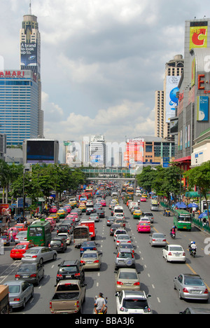 Grande città, ingorghi di traffico, auto e ciclomotori, nella parte anteriore del coloratissimo skyline, Ratchadamri Road, Bangkok, Thailandia, Sud-est asiatico Foto Stock