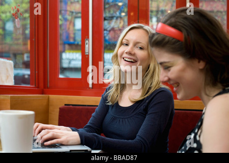 Due giovani donne seduti in un caffè insieme Foto Stock