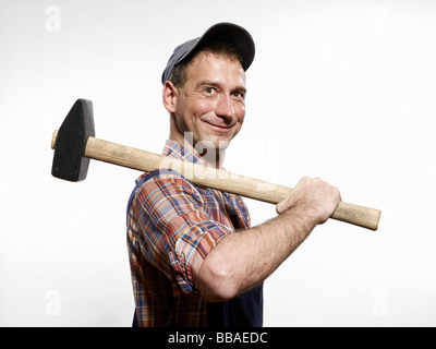 Un uomo con una mazza sulla sua spalla Foto Stock