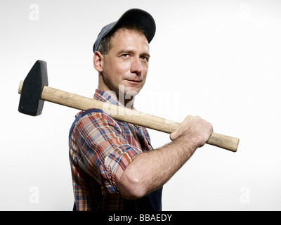 Un uomo con una mazza sulla sua spalla Foto Stock