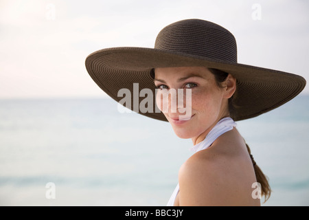 Donna sulla spiaggia sorridente in telecamera Foto Stock