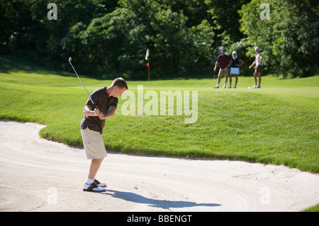 Veduta laterale dell uomo nella trappola di sabbia sul campo da Golf Foto Stock