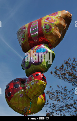 Buon compleanno con palloncini a faccia sorridente che fluttuano contro un cielo blu da vicino dal basso angolo di visuale frontale nessuno negli Stati Uniti ad alta risoluzione Foto Stock