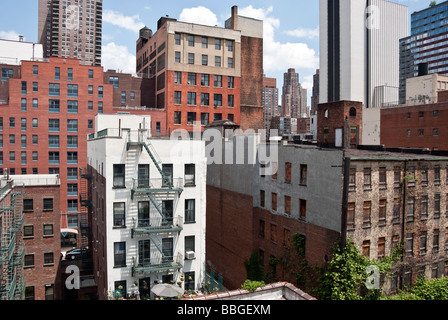 Vecchio e nuovo e ristrutturato edifici visto contro la rapida evoluzione skyline di Hells Kitchen, Manhattan, New York City, Stati Uniti d'America Foto Stock