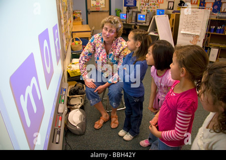 Kindergarten agli studenti di utilizzare una lavagna interattiva in aula di una scuola pubblica a Boise Idaho USA MR Foto Stock