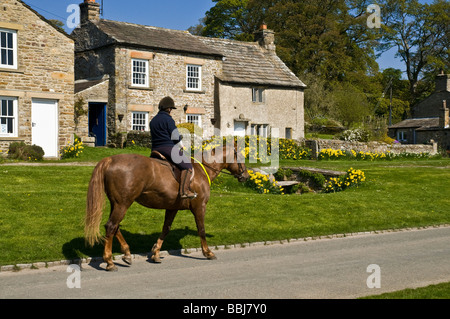 dh Yorkshire Dales National Park CASTLE BOLTON NORTH YORKSHIRE Horserider primavera Wensleydale villaggio cottage villaggi horseriding vita rurale Foto Stock