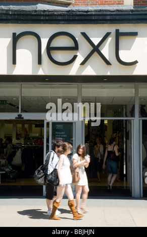 Le ragazze adolescenti al di fuori il prossimo negozio, Sidney Street, Cambridge, Regno Unito Foto Stock