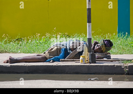Senzatetto donna dorme sul marciapiede Quelimane Mozambico Foto Stock