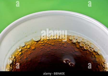 Coca Cola bolle servita in un vetro bianco su un tavolo verde. Bevande, freddo, bere, vetro, Coca Cola, Coke e Pepsi Ice Foto Stock