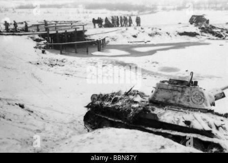Eventi, Seconda guerra mondiale / seconda guerra mondiale, Russia 1944 / 1945, fanteria tedesca che marciano in un'area di assemblaggio per un contrattacco, vicino Britskoye, Ucraina, fine gennaio 1944, in primo piano un knocked out sovietico T-34/76 serbatoio, carri armati, inverno, Wehrmacht, neve, URSS, soldati, fiume, ponte, ghiaccio, paesaggio, colonna, strada, tedeschi, 20th secolo, Storico, storico, T34, T 34, distrutto, Army Group South, Eastern Front, People, 1940s, Foto Stock