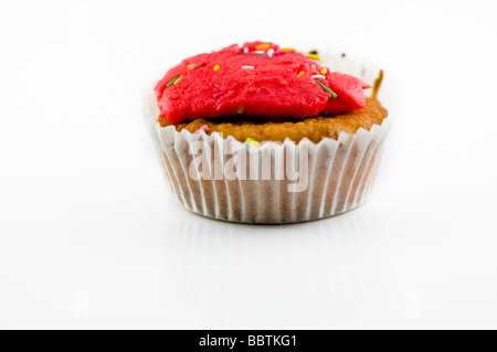 Un muffin gustosi con crema rosso isolato su sfondo bianco Foto Stock