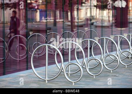 Una fila di Rastrelliere per biciclette riflessa nelle finestre del palazzo pubblico in West Bromwich West Midlands England Regno Unito Foto Stock