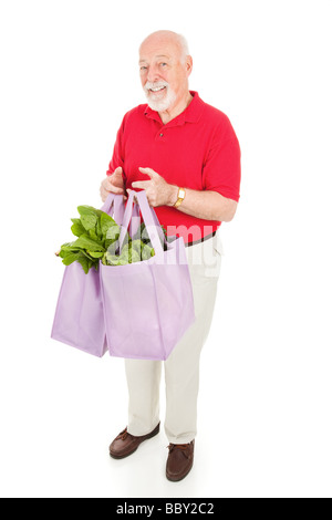 Senior sano uomo porta a casa i generi alimentari in panno riutilizzabile shopping bags isolato su bianco Foto Stock