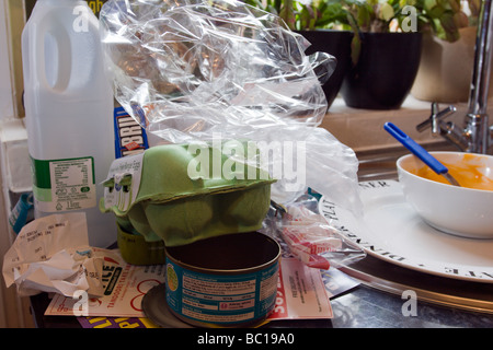 Pasticcio in cucina con i rifiuti di accatastamento sul piano di lavoro della cucina in attesa di essere riciclato Foto Stock