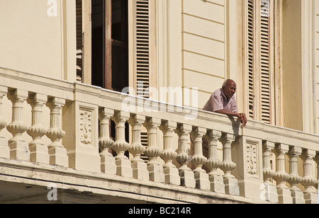 Uomo cubano permanente al balcone che si affaccia sul Prado, Havana, Cuba Foto Stock
