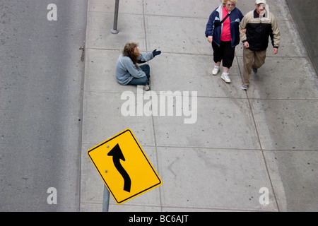 Ricchi poveri dividono le disuguaglianze, Vancouver Canada senzatetto mendicante gastown implacando denaro dai turisti Foto Stock