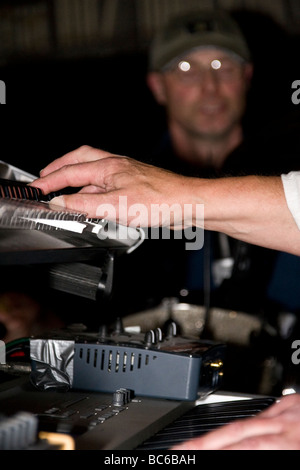 Primo piano di un musicista con le mani in mano in azione suonare le tastiere durante un concerto di Blues presso il bar della città di Dundee, Regno Unito Foto Stock