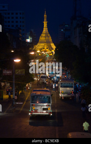 Vista lungo il bus-affollato Mahabandoola road per la Sule Pagoda nel centro della città di Yangon, Myanamar, di notte Foto Stock