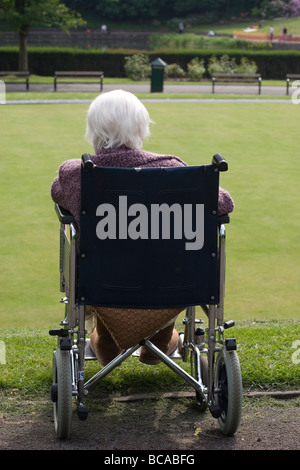 Molto infelice old Lady in sedia a rotelle in posizione di parcheggio Foto Stock