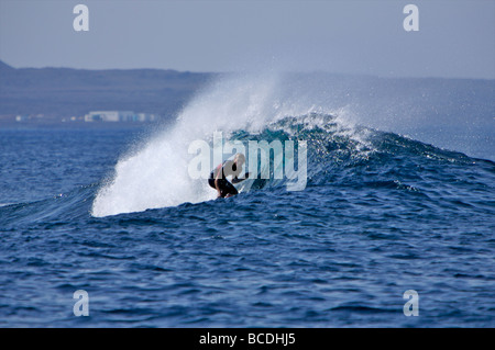 Surfista britannico Tom Lowe indietro di taglio in corrispondenza di un punto da surf noto come pipeline in Fuerteventura Foto Stock